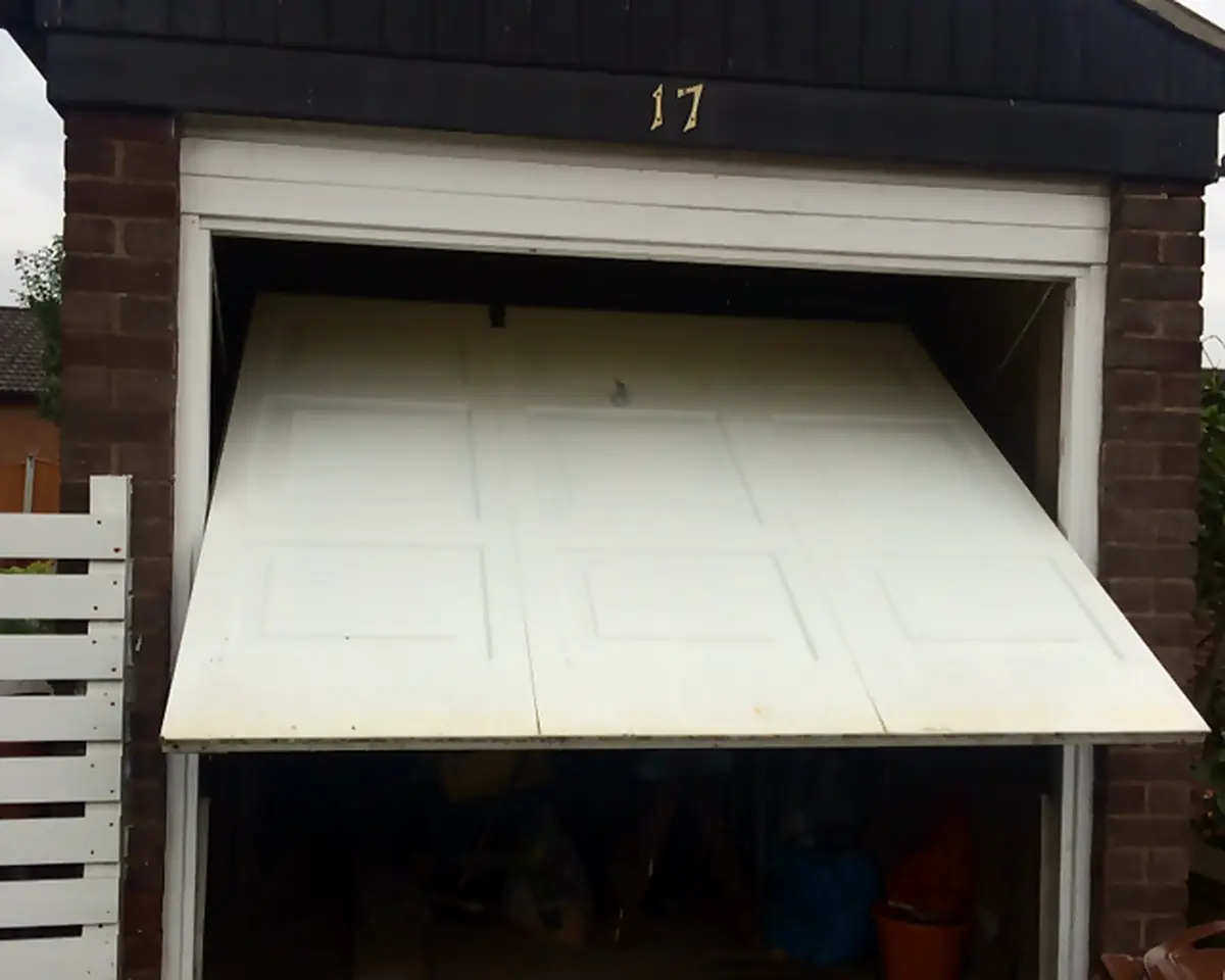 The same panelled door back on its runners, sitting level as it opens